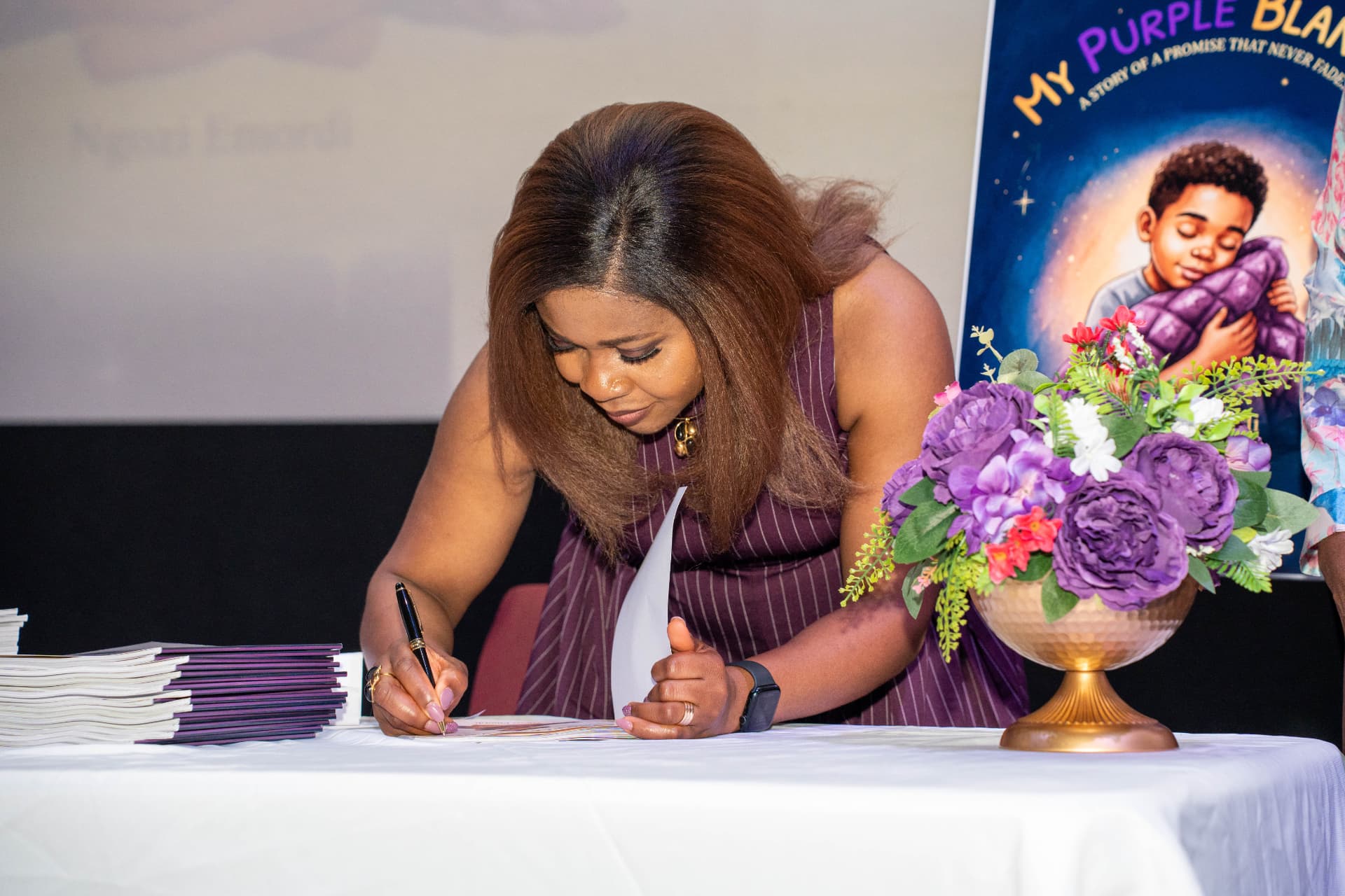 Ngozi signing books at the launch table